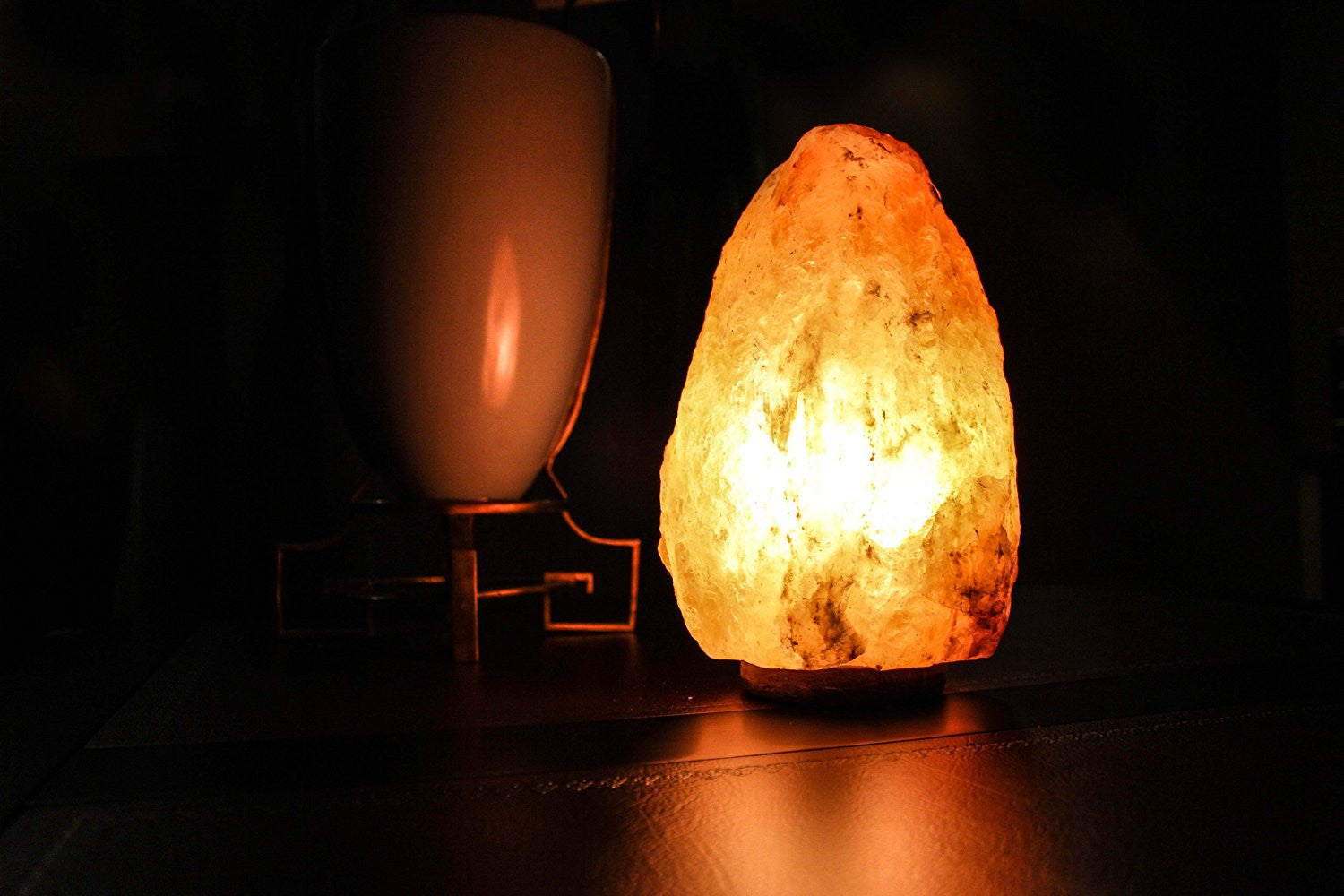 natural Himalayan salt lamp on wood base close up Negative Ion Store